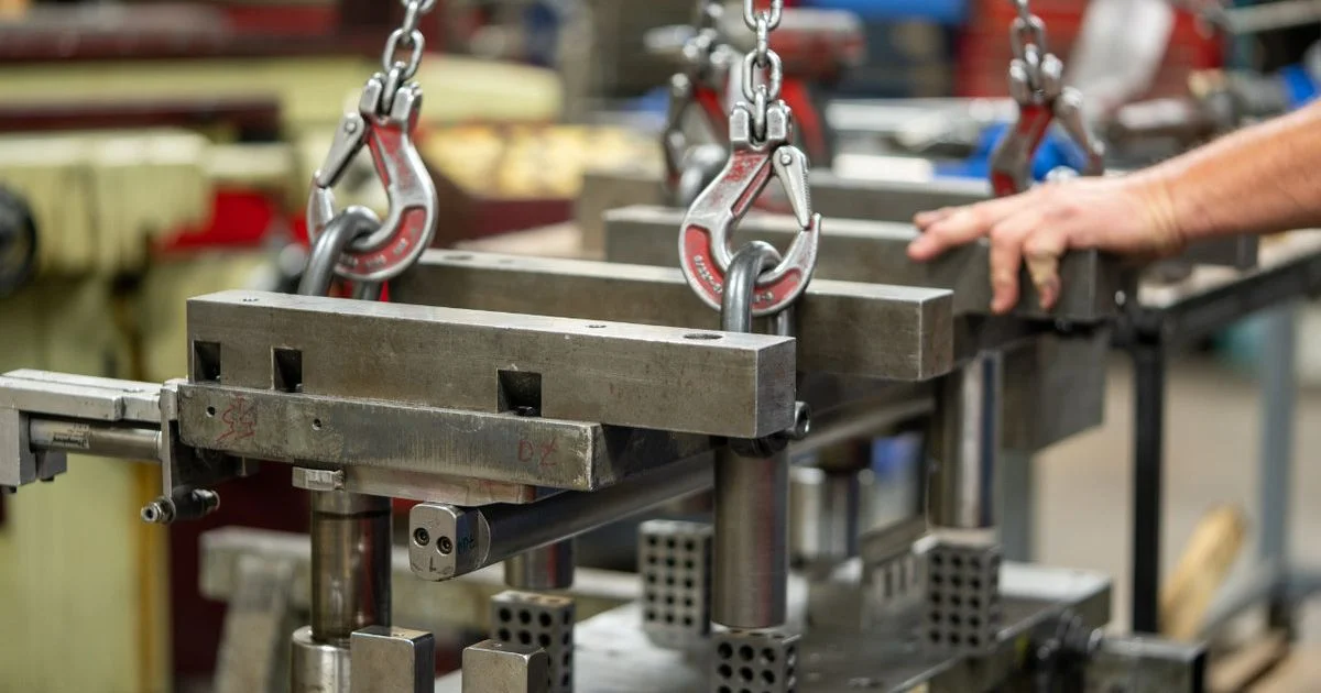 Heavy industrial metal stamping with lifting clamps